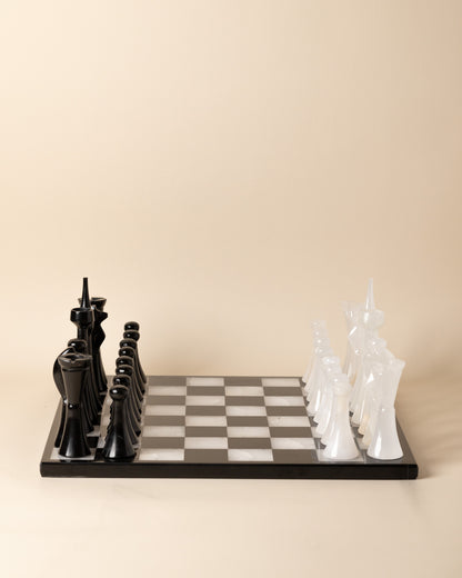 Chessboard with black and white chess pieces on a beige background