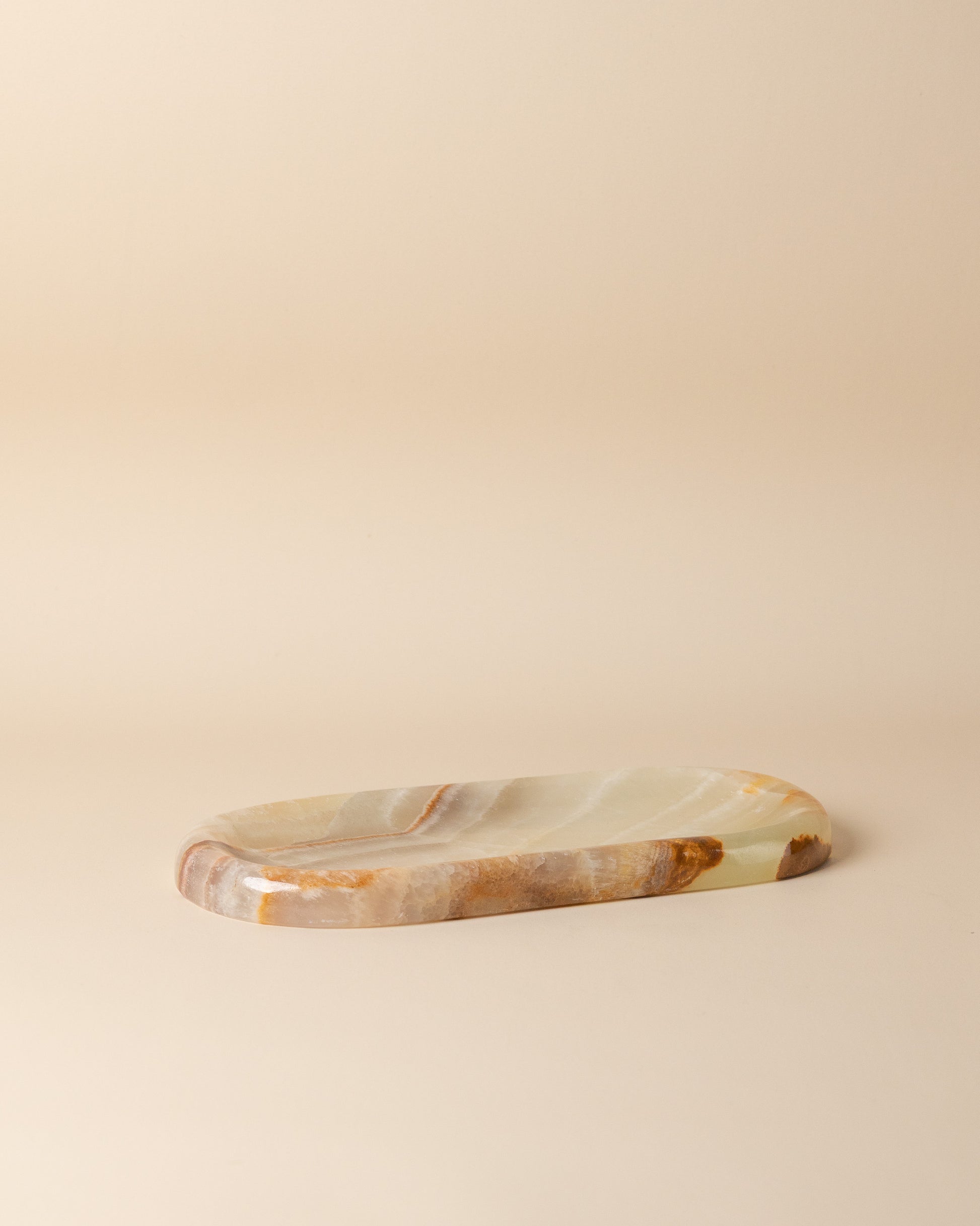 Marble-patterned stone tray on a beige background